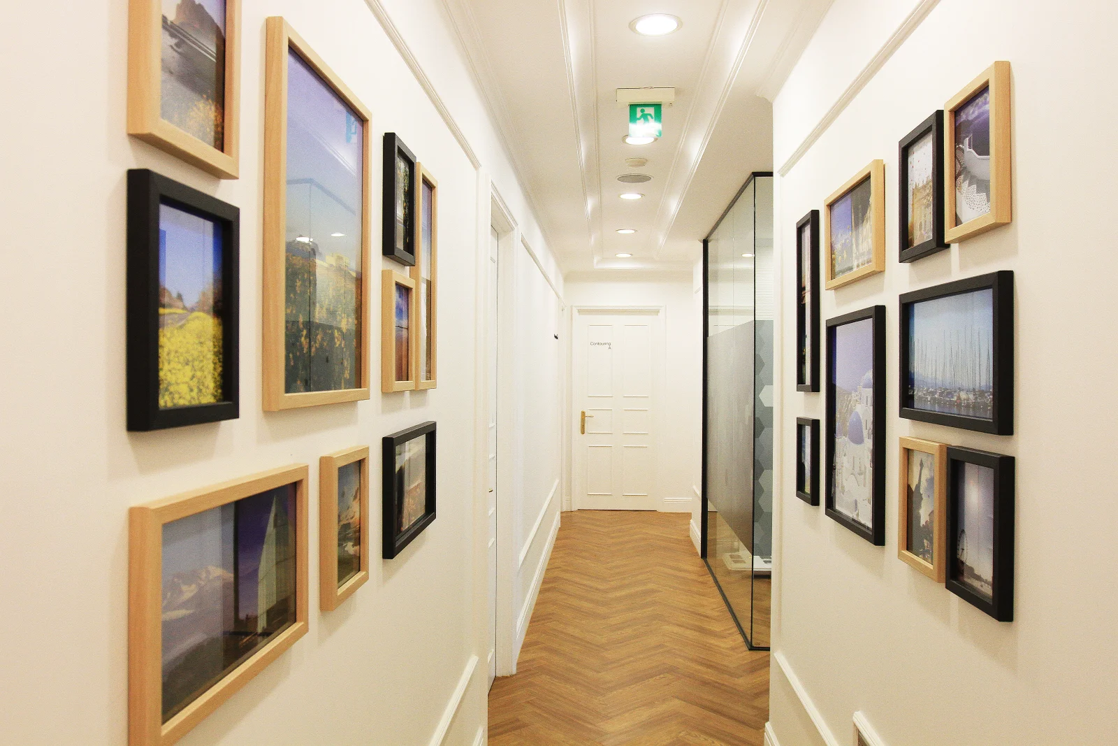 Framed-photo corridor between treatment suites at G Clinic, Gangnam